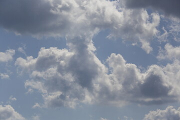 white fluffy clouds in the blue sky.