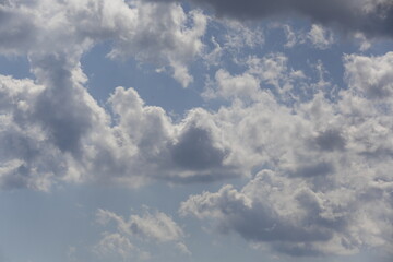 white fluffy clouds in the blue sky.