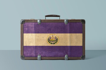El Salvador flag on old vintage leather suitcase with national concept. Retro brown luggage with copy space text.