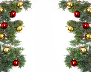 Fototapeta na wymiar Christmas juniper background on a white background with gold and red balls.