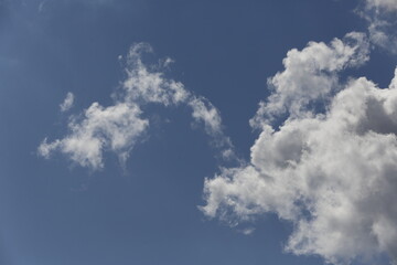 white fluffy clouds in the blue sky.