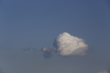 white fluffy clouds in the blue sky.