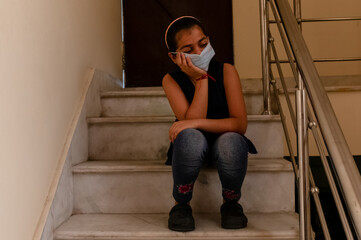 A young girl wearing Medical Mask on her face to prevent herself from Viruses and germs