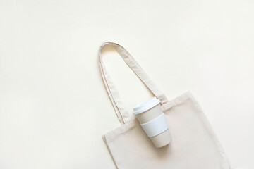 Cotton bag, thermos, glass bottle with lemon water and Melissa bamboo tubes. Let's go shopping. Ecological, natural materials.