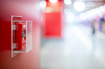 The red fire alarm switch on the red wall at the Bangkok subway. - obrazy, fototapety, plakaty