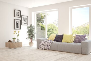 White living room with sofa and summer landscape in window. Scandinavian interior design. 3D illustration