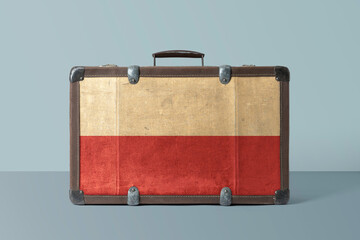 Poland flag on old vintage leather suitcase with national concept. Retro brown luggage with copy space text.