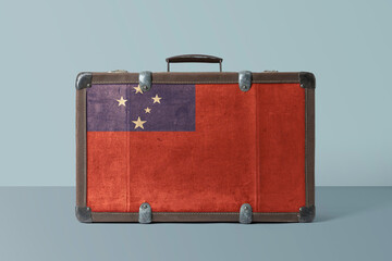 Samoa flag on old vintage leather suitcase with national concept. Retro brown luggage with copy space text.