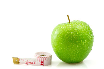 Isolated green apple with measuring tape on white, concept of healthy and diet.