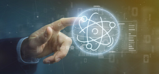 Businessman holding an atom icon surrounded by data