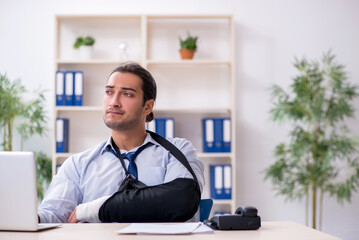 Injured male employee at workplace after accident