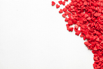 Red hearts on background, top view
