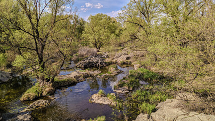 The landscape park of the Ukrainian castle Radomysl with waterfalls, islands and rare plants on a spring day. Museum of Ukrainian Medic and Politics Olga Bogomolets