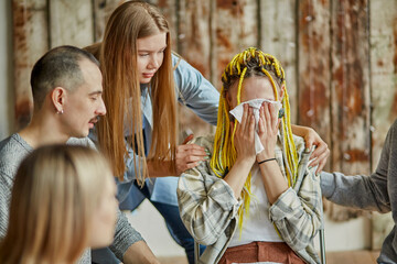 young female is ashamed to admit that he is addicted to alcohol or drugs, he came to get support and psychological help from others in the club of anonymous alcoholics. woman cry