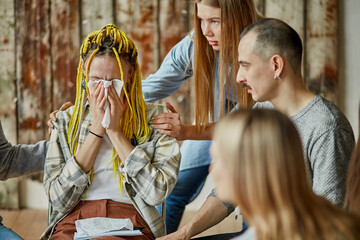 female cry in the club of anonymous alcoholics, woman needs psychological help, people support and hug her