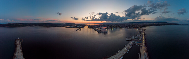 Fototapeta premium Drone Panorama of the Sea and the Varna Sea Port at sunset time with dramatic sky