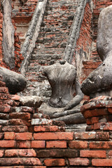 Fototapeta na wymiar Old Buddha statue without head in the midst of ruins of the Chaiwatthanaram Temple Ayutthaya, Thailand.