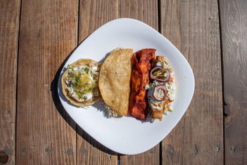 top view of variety of mexican food like sope, tacos and enchilada
