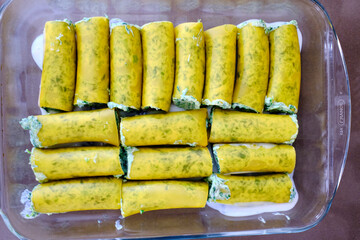 Homemade preparation of typical Italian cannelloni with ricotta and spinach.