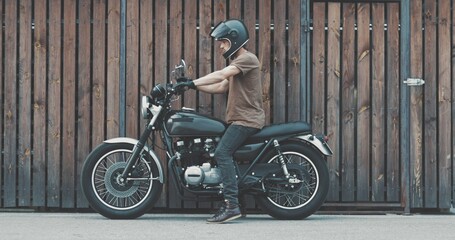 Handsome rider guy with classic style motorcycle