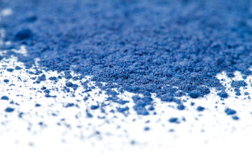 Powdered blue matcha tea on a white background. Selective focus. Macro photography.