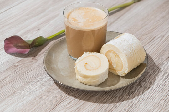 Brazo de gitano casero con caf&eacute; con leche desayuno rom&aacute;ntico con flor