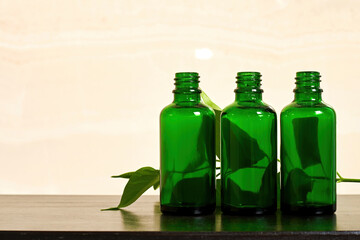 Transparent bottles with body care cream in the bathroom. Traditional cosmetic and personal care products. Herbal medicine. Copy space for advertisement text