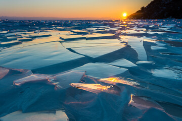 broken ice floes on Lake Baikal on the Sunset