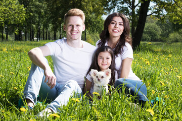 Family with pet dog in park