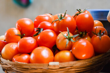 Fresh and ripe red tomato kept in the basket  for sale.