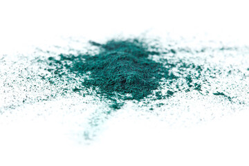 Fototapeta premium Splash of spirulina algae powder isolated on a white background. Superfood concept.