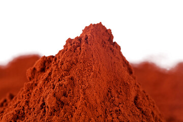 Heap of cacao powder on a white background.