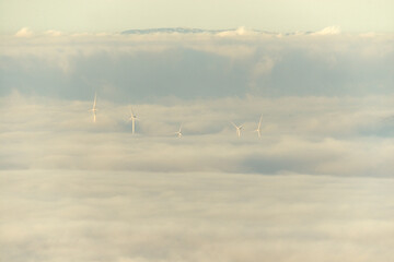 Fototapeta na wymiar paisaje de naturaleza nubes y molino de viento en el monte
