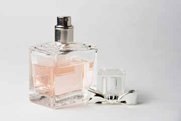 pink women's perfume bottle in a rectangular glass bottle on a white background