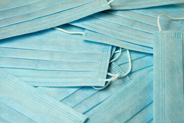 many medical disposable masks are scattered close up view from above