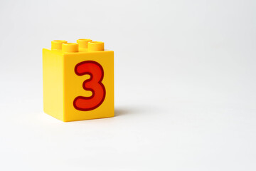 the number three written on the block from the children's constructor
