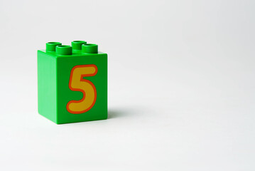 the number five written on the block from the children's constructor