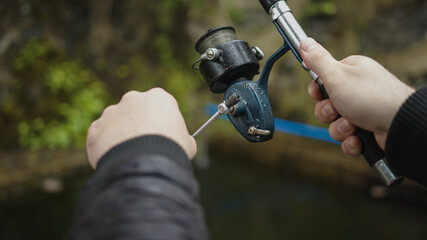 Fishing rod and hand close-up