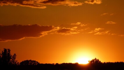 Orange sunset on the cloudy sky