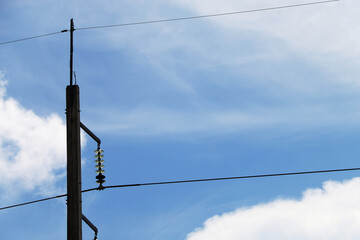 Close-up of transmission line at the top of the electricity pole