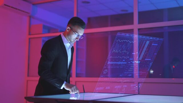 The businessman working with a virtual holograhic screen