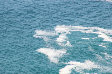 A seascape of Kelingking beach sea shore water wave from the top in a beautiful sunny summer day in Nusa penida