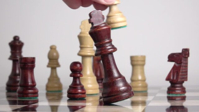 Chess king falling in slow motion. Board game ending in defeat. Concept of winning, strategic thinking and result.
