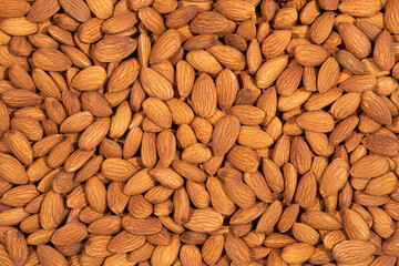 Raw peeled almonds full frame for background.