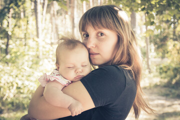 Young mother with her little baby. Loving mother takes care of her daughter