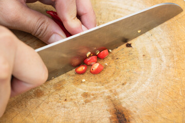Sliced ​​red peppers on a wood chopping board