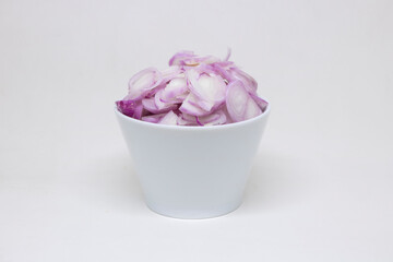 Obraz na płótnie Canvas Sliced ​​onions in a white cup on a white background