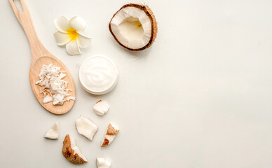 Fototapeta na wymiar Homemade coconut products on white wooden table background. Oil, scrub, milk, lotion, mint and himalayan salt from top view. Good for space and background