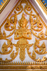 Fototapeta na wymiar Golden fresco of a buddha image in a wat or buddhist temple site in Siamese Lao PDR, Southeast Asia