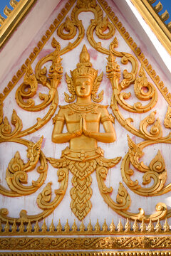 Golden fresco of a buddha image in a wat or buddhist temple site in Siamese Lao PDR, Southeast Asia